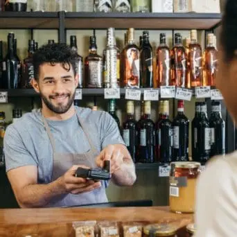 Customer paying at an alcohol outlet