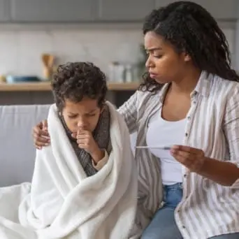 Worried mother with a sick child.