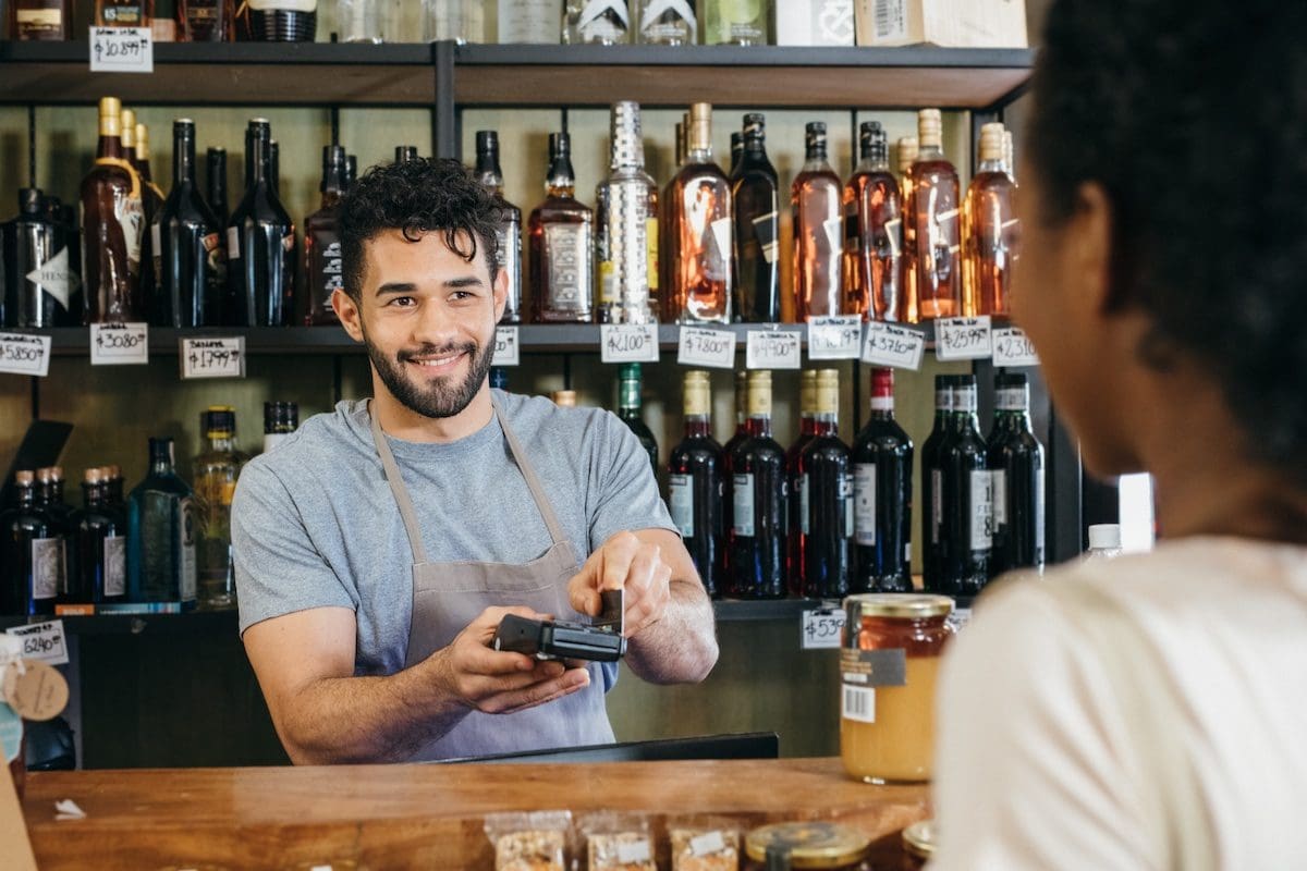 Customer paying at an alcohol outlet